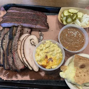 Tray feeds 2-3. . Pork rib, brisket, turkey, Mac and cheese, Brunswick stew, chess cake, pickles and pickled onions