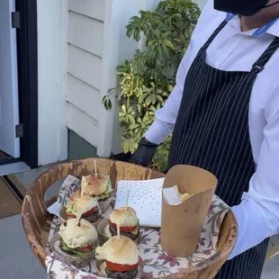 Passed hors d' oeuvres mini sliders and flavored fries in a cup