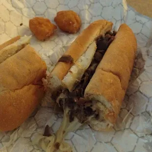 Steak and cheese with a couple of corn nuggets.