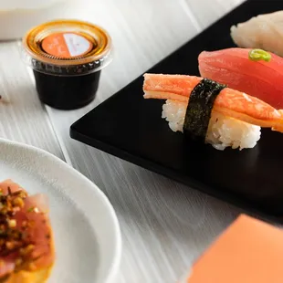 a plate of sushi and chopsticks