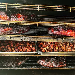 a variety of meats being cooked