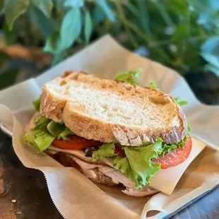 a sandwich with lettuce, tomato, and turkey