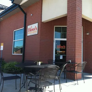 outside of restaurant with tables and chairs