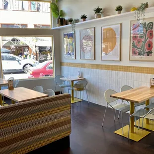 a view of a restaurant with tables and chairs