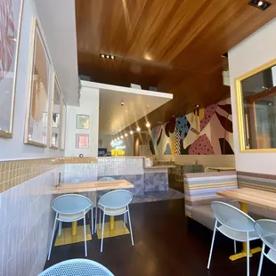the interior of a restaurant with tables and chairs