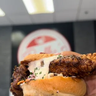 a hand holding a sandwich