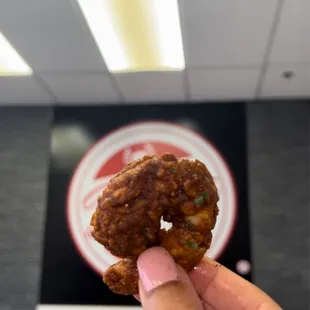 a hand holding a piece of food