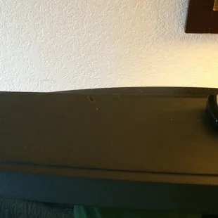 Cigarette burn on the TV in the smoke-free room.