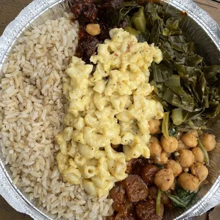 Large portion. Clockwise from top: BBQ, collard greens, chickpeas, sweet &amp; sour, brown rice and mac and cheese on top.