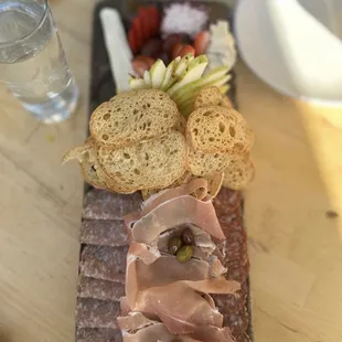 a platter of meat and bread