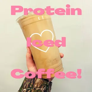 a hand holding a cup of protein iced coffee