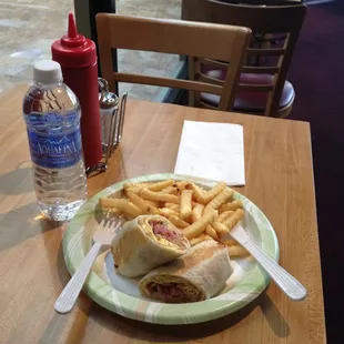 Meat lovers breakfast wrap with garlic fries and bottled water.