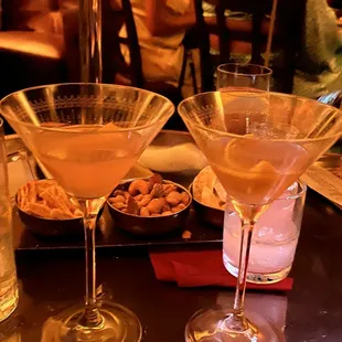 At one of the tables. One dirty martini and one Cosmo.