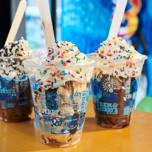Three ice cream sundaes in the Ben &amp; Jerry's ice cream shop.