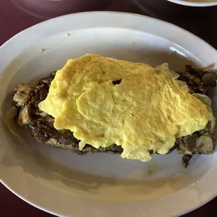 Prime rib hash buried under scrambled eggs