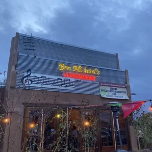 Outside, on corner.  Charming restaurant