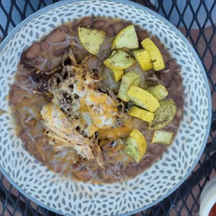 A bowl of delicious pinto beans with organic squash and wonderful pork it was just fantastic