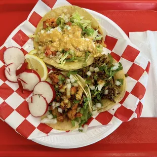 Starting from the top and in clockwise order: shrimp, asada steak and chicken tacos.