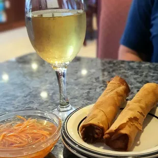 a plate of food and a glass of wine