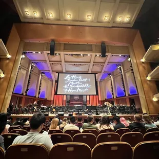 a concert hall with a large screen