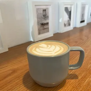 latte art inside a coffee coffee mug, framed photography in the background
