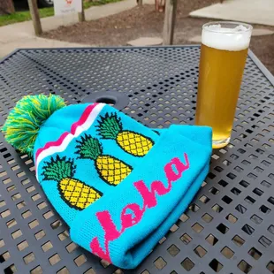 a cold beer and a pineapple beanie