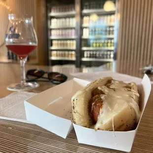 a hot dog and a glass of wine