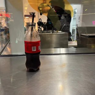 a bottle of coke on a counter