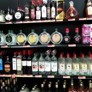 a shelf full of liquor bottles