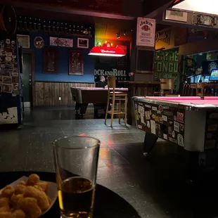 a pool table and a glass of beer