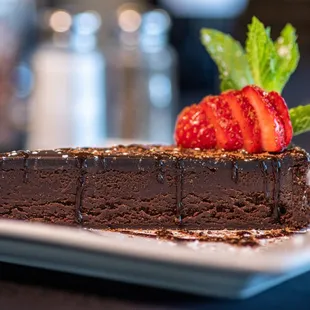 a piece of chocolate cake with strawberries on top