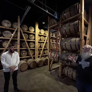 a man in a white shirt and a bearded man in a black shirt standing in front of a