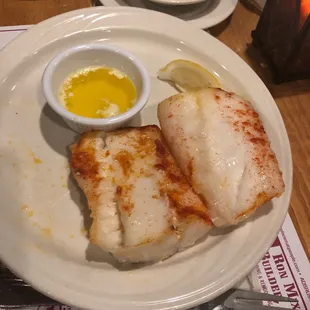a plate of fish with a side of coleslaw