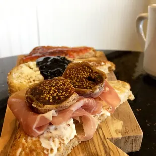 Toast flight (front to back): marscarpone-prosciutto-fig, goat cheese-blueberry-balsamic jam, homemade strawberry jam.