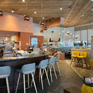 a restaurant with a bar and chairs