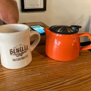 a coffee pot and a mug on a table