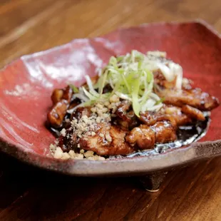 Black Miso Chicken - Broiled dark meat chicken in a savory black miso sauce, with crushed walnuts and black sesame, topped with scallions