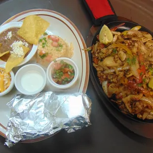 Fajitas with rice, beans, sour cream,pico de gallo,cheese, and tortillas