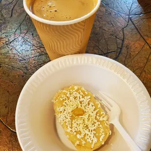 a cup of coffee and a donut on a plate