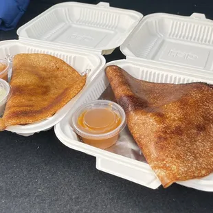a fried chicken in a styrofoam container