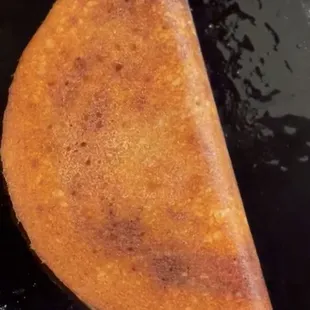 an indian flatbread in a frying pan