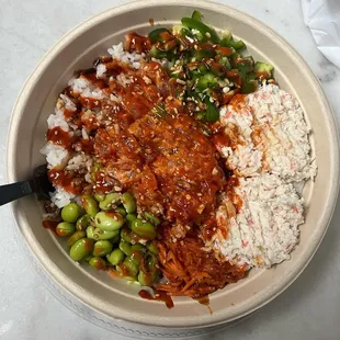 a bowl of rice, beans, and meat