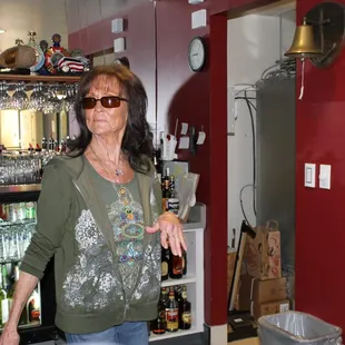 a woman standing in front of a bar