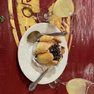 a plate of food and a glass of orange juice