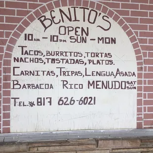 a brick wall with a sign on it