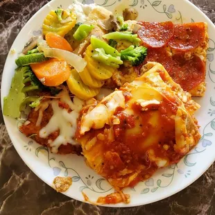 Lunch buffet items at Benito&apos;s. Lasagna, pizza,chicken Parmigian, veggies.