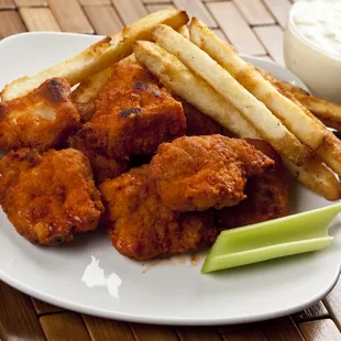 a plate of chicken wings and fries