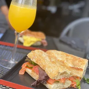 a sandwich and a glass of orange juice