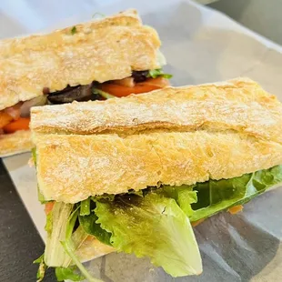 a sandwich with lettuce and tomato