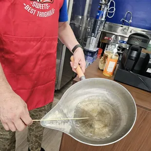 This is the pan they use to dip the fruit skewers into the melted sugar...
